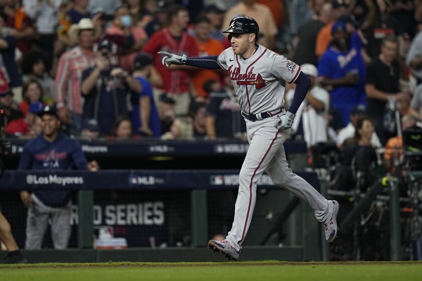 Atlanta Braves' Freddie Freeman celebrates a home run during the seventh inning.