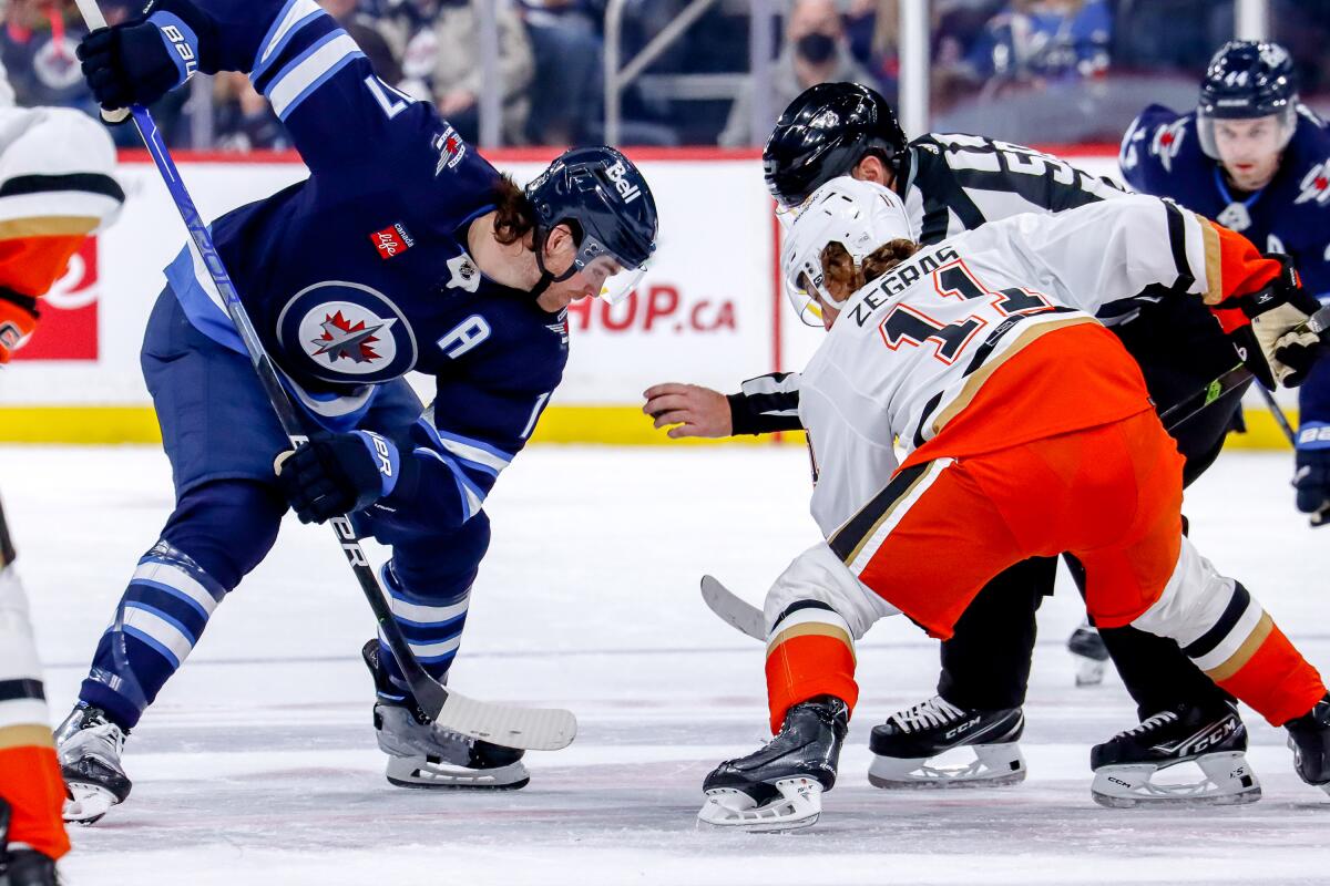 WINNIPEG, CANADA - DECEMBER 4: Adam Lowry #17 of the Winnipeg Jets gets set for a second period.