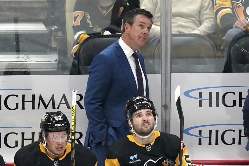 FILE - Pittsburgh Penguins head coach Mike Sullivan stands behind his bench during the first period of an NHL hockey game against the Nashville Predators, Monday, April 15, 2024, in Pittsburgh. Sullivan has been named U.S. coach for the 2026 Milan Olympics. USA Hockey announced the long-expected decision Saturday, May 18 while also saying the Pittsburgh Penguins coach will be behind the bench for the NHL's Four Nations Face-Off tournament next year. (AP Photo/Matt Freed, File)