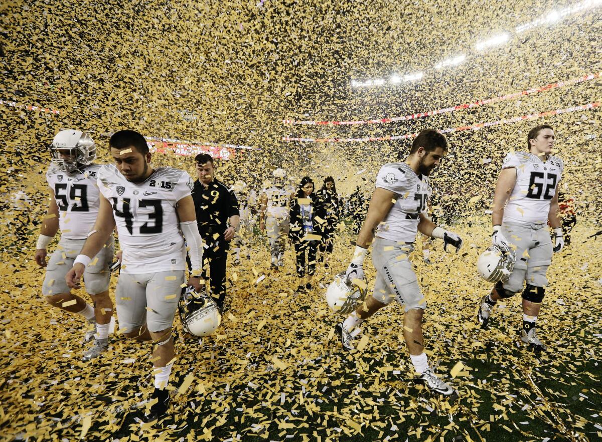 Oregon players leave the field at AT&T Stadium after their 42-20 loss to Ohio State in the College Football Playoff championship game.