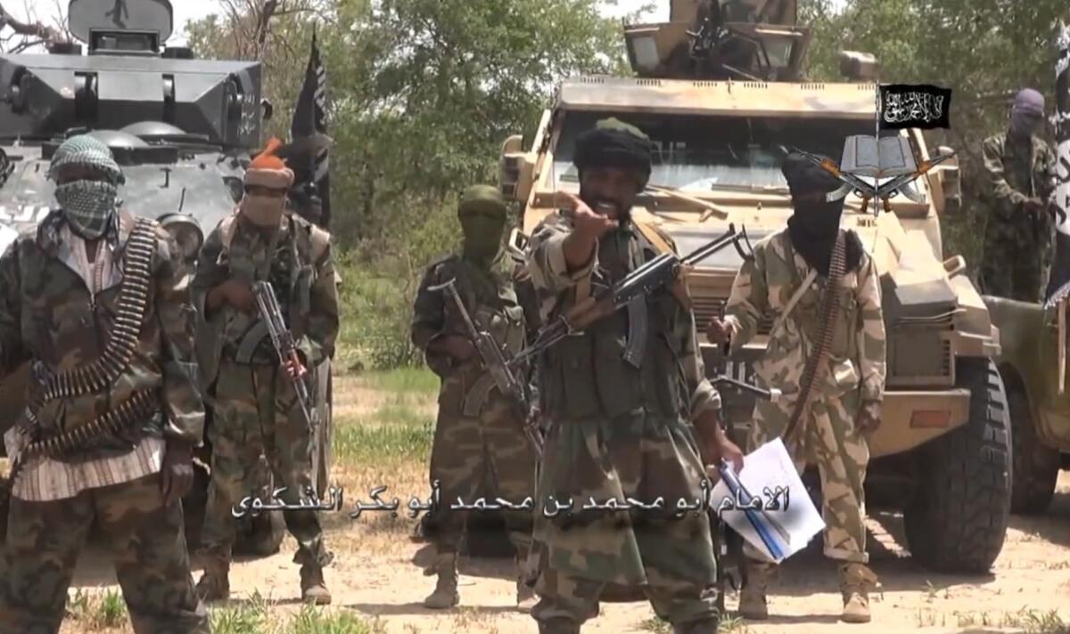An image from video released July 13 by Boko Haram shows the Nigerian Islamist group's leader, Abubakar Shekau, center. Boko Haram fighters reportedly attacked a village in northeastern Nigeria on Friday, killing civilians.