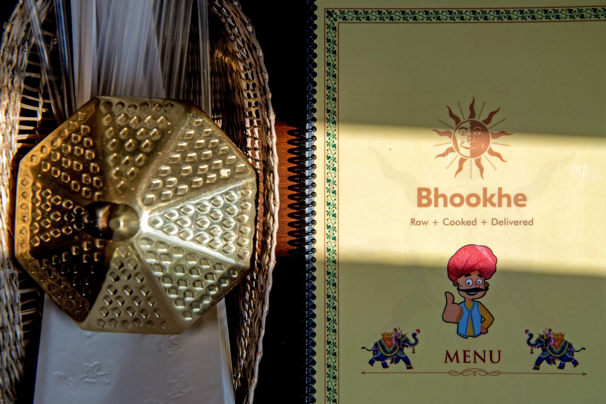 A Bhookhe menu atop a table in the restaurant
