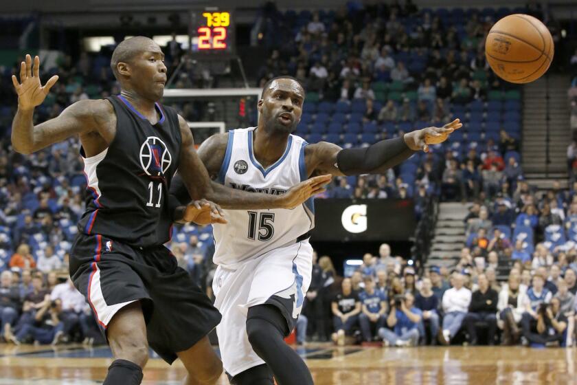 Timberwolves forward Shabazz Muhammad (15) passes to a teammate away from Clippers guard Jamal Crawford (11) during the first half.