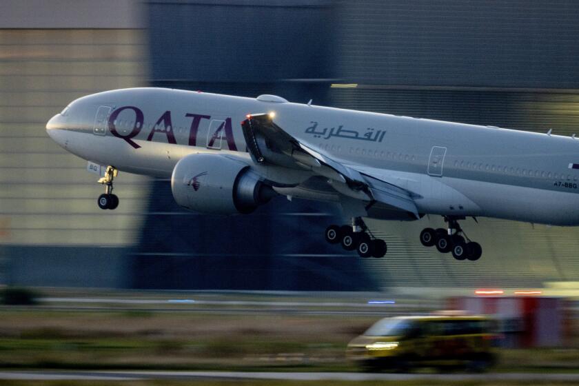 FILE - A Qatar airways plane lands at the airport in Frankfurt, Germany, as the sun rises on Sept. 25, 2023. Twelve people were injured when a Qatar Airways plane flying from Doha to Dublin on Sunday May 26, 2024 hit turbulence, airport authorities said. (AP Photo/Michael Probst, File)