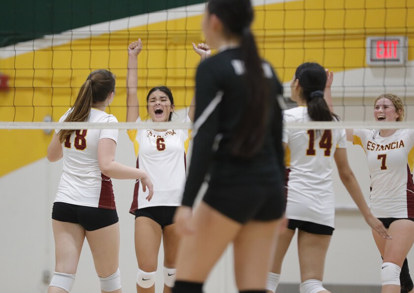 Estancia's Sydney Bilderback (6) celebrates a point with teammates Makena Ray (18), Natalie Aguayo (14) and Ruby Uchytil.