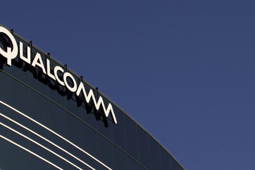 FILE - In this Nov. 2, 2011, file photo, a sign sits atop the Qualcomm headquarters building in San Diego. Qualcomm is raising its takeover bid for NXP Semiconductors by nearly 16 percent to about $43.22 billion, citing in part NXP's strong results since the companies first announced their merger in October 2016. The move announced Tuesday, Feb. 20, 208, comes as Qualcomm itself is in the crosshairs of Broadcom Ltd., which earlier this month raised its own cash and stock bid for Qualcomm to $121 billion. (AP Photo/Gregory Bull, File)