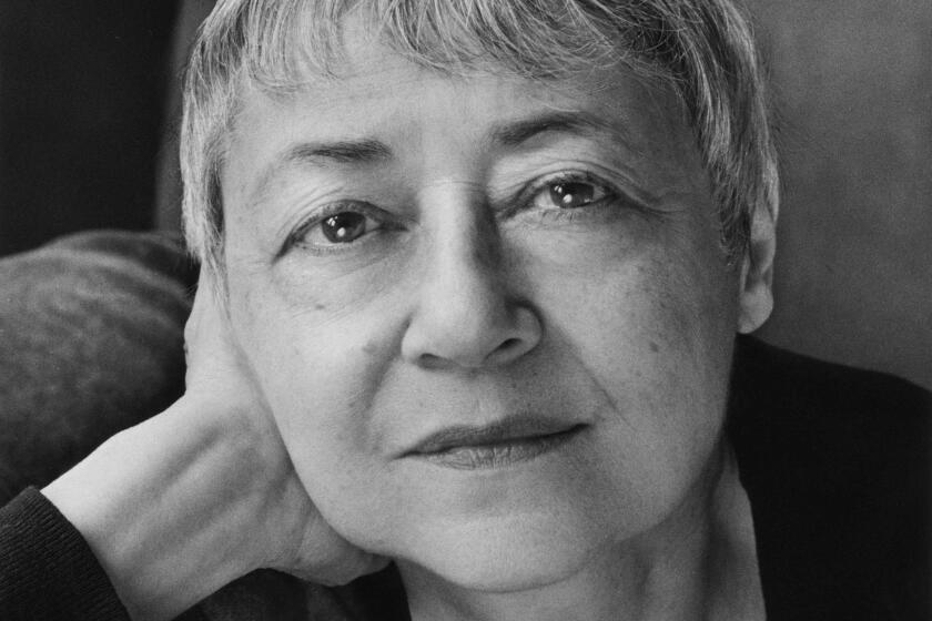 Sigrid Nunez, an author, poses in a black and white photo with short gray hair and an enigmatic smile.