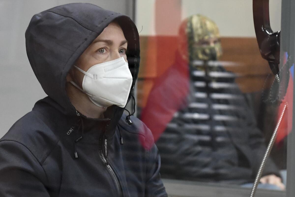 Russian American journalist Alsu Kurmasheva in a cage in a Russian courtroom