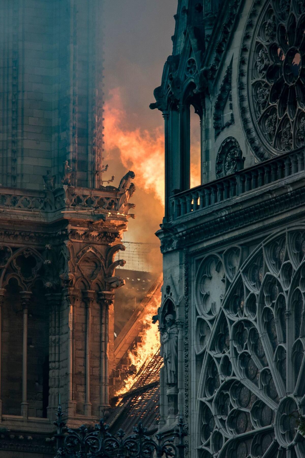 Flames and smoke are seen billowing from the roof at Notre-Dame Cathedral in Paris on April 15, 2019. - A huge fire swept through the roof of the famed Notre-Dame Cathedral in central Paris on April 15, 2019, sending flames and huge clouds of grey smoke billowing into the sky. The flames and smoke plumed from the spire and roof of the gothic cathedral, visited by millions of people a year. A spokesman for the cathedral told AFP that the wooden structure supporting the roof was being gutted by the blaze. (Photo by THOMAS SAMSON / AFP)THOMAS SAMSON/AFP/Getty Images ** OUTS - ELSENT, FPG, CM - OUTS * NM, PH, VA if sourced by CT, LA or MoD **