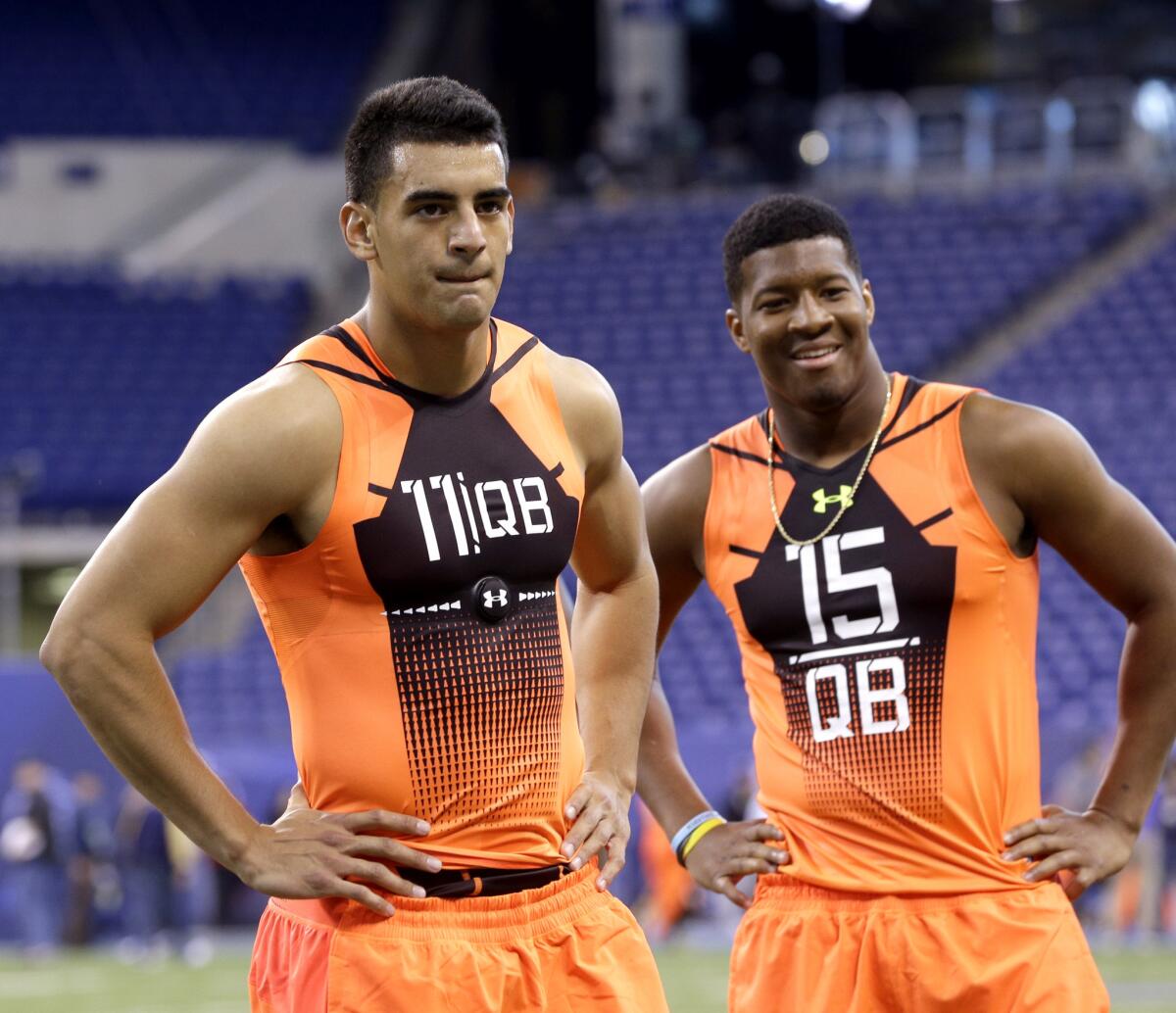 Oregon quarterback Marcus Mariota and Florida State quarterback Jameis Winston wait to run a drill at the NFL scouting combine on Feb. 21.