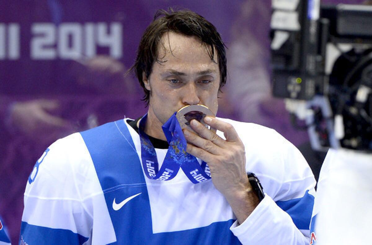 Finland captain Teemu Selanne kisses his bronze medal at the Bolshoy Ice Dome after defeating the U.S., 5-0.