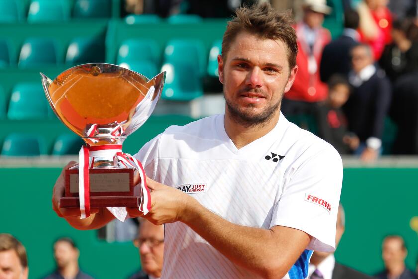 Stanislas Wawrinka poses with the Monte Carlo Masters trophy after defeating Roger Federer in the final on Sunday.