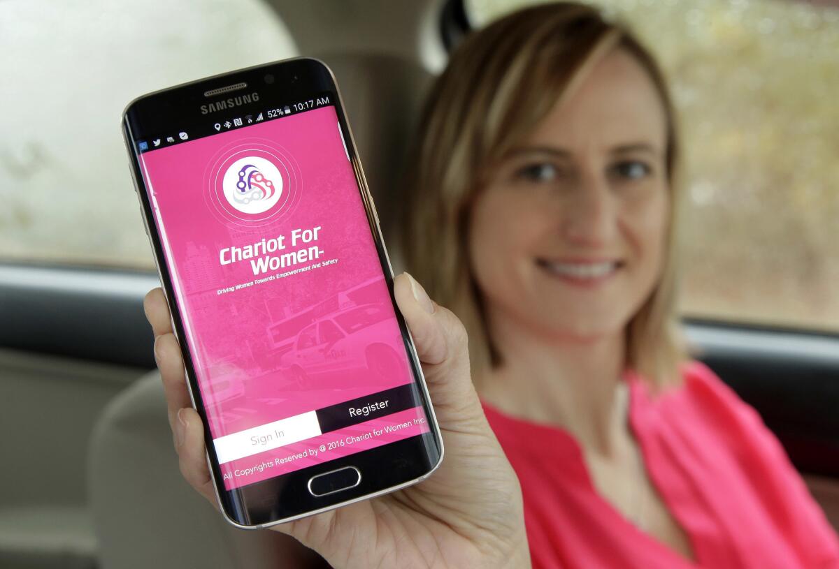 Kelly Pelletz, co-creator of the ride-hailing service Chariot for Women, displays the app on a mobile phone.