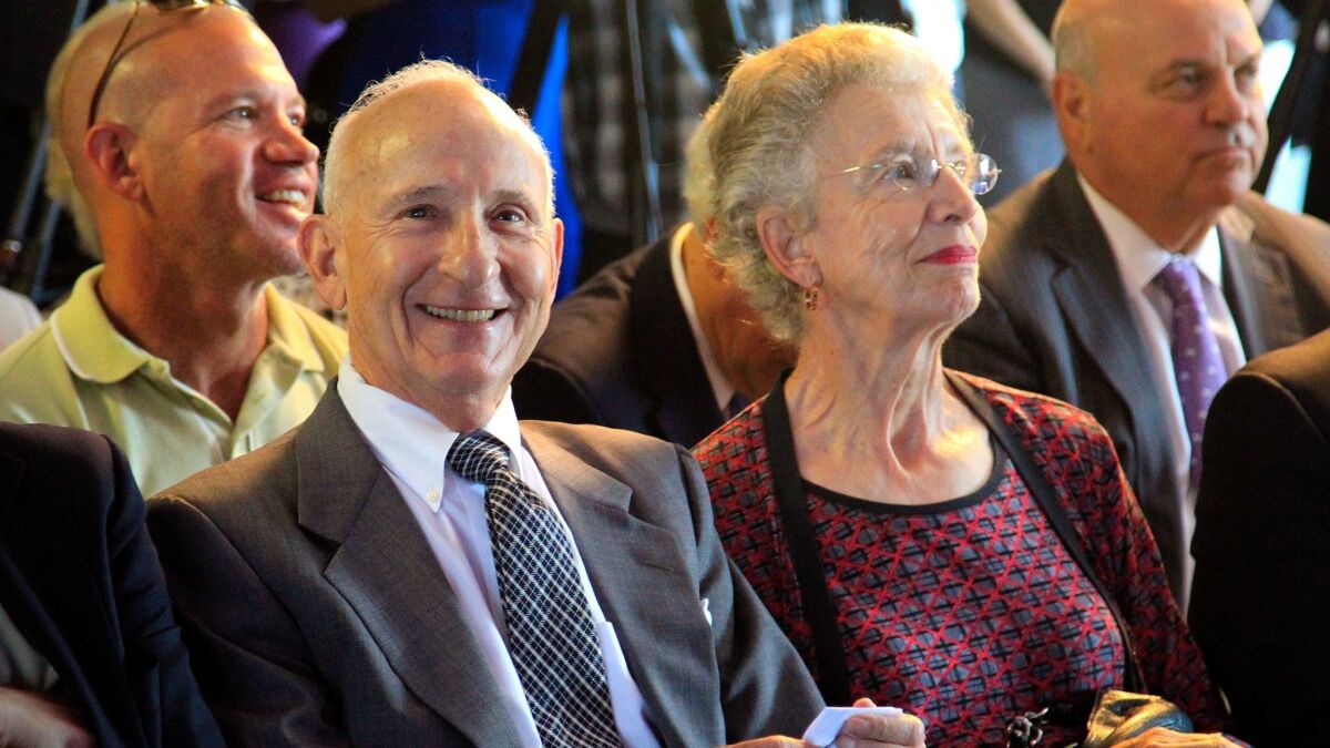August 4, 2014, SAN DIEGO, CA | Ernest Rady, left, and his wife, Evelyn Rady, right, are all smiles during the announcement of their $120 million pledge Monday to Rady Childrens Hospital, to create the Rady Pediatric Genomics and System Medicine Institute at the hospital that already bears their family name. The Institute will be capable of sequencing and analyzing the genome of every incoming patient. |Photo by Howard Lipin/U-T San Diego/Mandatory Credit: HOWARD LIPIN/U-T SAN DIEGO/ZUMA PRESS | U-T San DIego photo by Howard Lipin copyright 2014