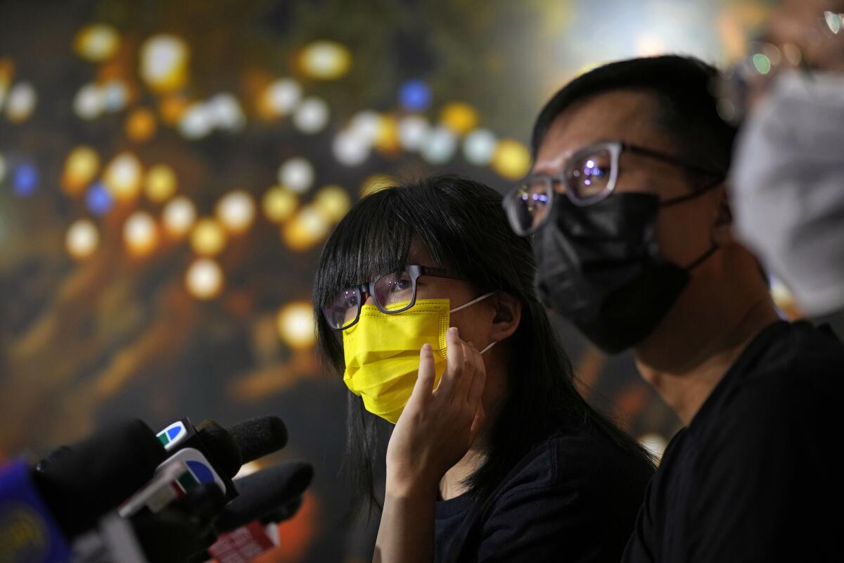 Chow Han Tung, left, vice chairwoman of the Hong Kong Alliance in Support of Patriotic Democratic Movements of China, and other group members attend a news conference in Hong Kong, Sunday, Sept. 5, 2021. The group behind the annual Tiananmen Square memorial vigil in Hong Kong said Sunday it will not cooperate with police conducting a national security investigation into the group's activities, calling it an abuse of power. (AP Photo/Kin Cheung)