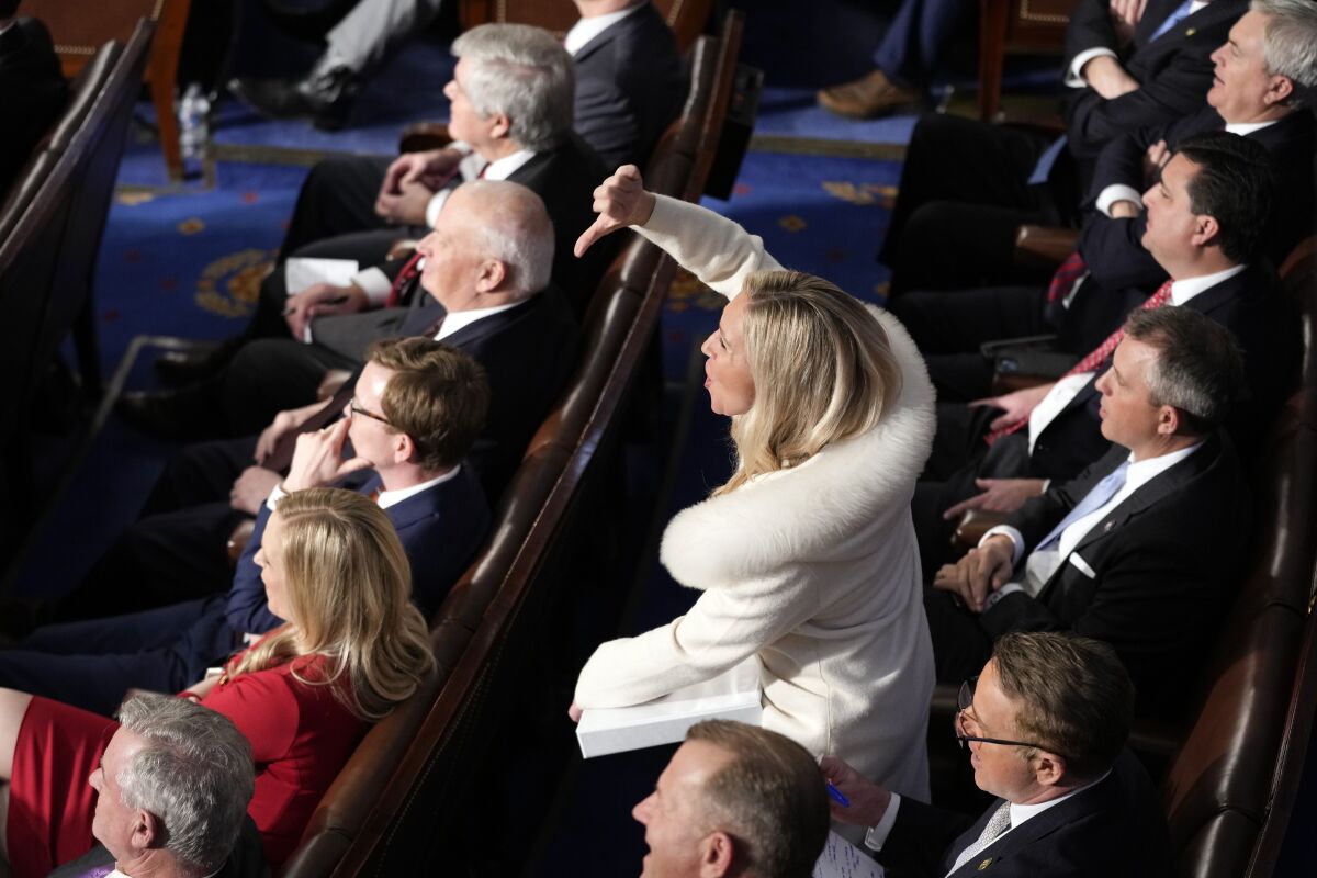 Rep. Marjorie Taylor Greene, R-Ga., reacts as President Joe Biden delivers the State of the Union address.