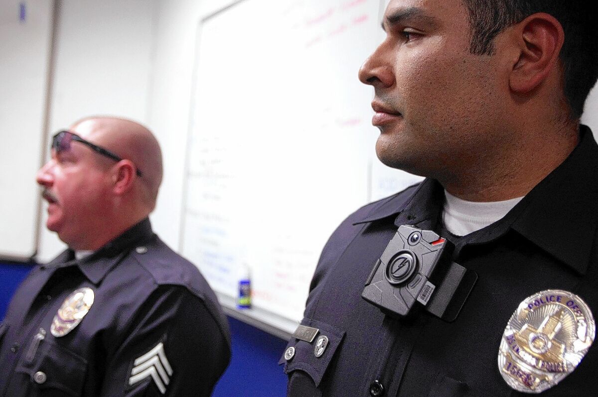 An LAPD officer wears a clip-on camera during a news conference in January. About 30 LAPD officers are testing various camera models.