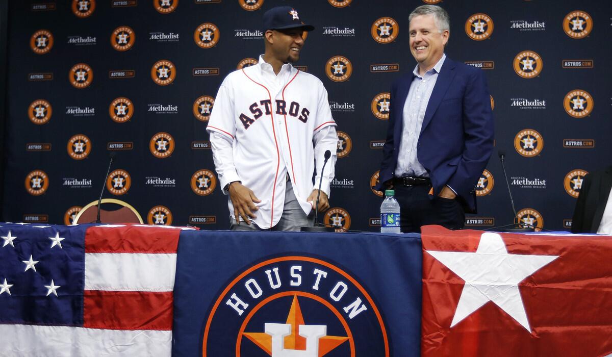 Cuban infielder Yulieski Gurriel, left, is introduced to the media by Houston Astros General Manager Jeff Luhnow on Saturday in Houston.