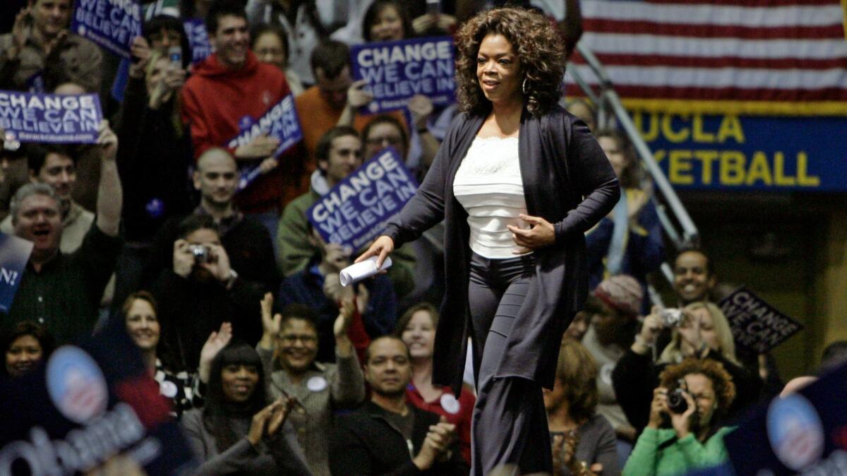 Oprah Winfrey makes her entrance at a campaign rally for then-Democratic presidential hopeful Barack Obama in Los Angeles on Feb. 3, 2008.