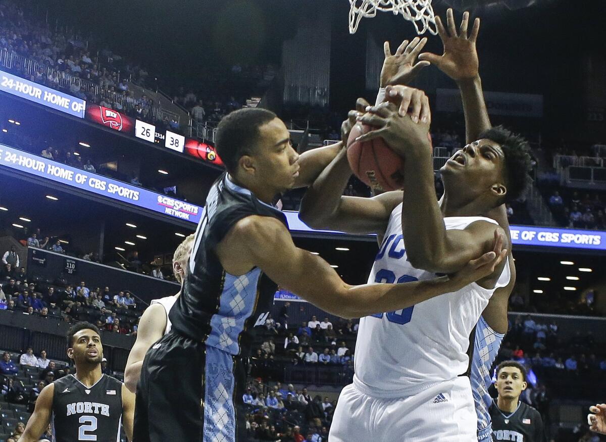 North Carolina's Brice Johnson (11) and UCLA's Tony Parker (23) fight for control of the ball in the first half Saturday.
