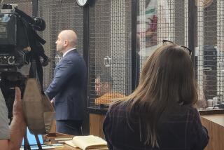 Dino Rojas-Moreno, center in orange, appears for his arraignment at the Central Justice Center in Santa Ana on Monday. He is charged with committing the murder of Tatum Goodwin.