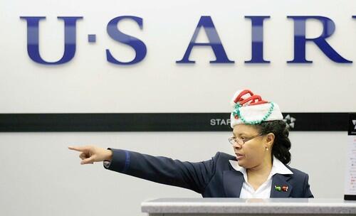 Festively capped U.S. Airways ticketing agent Elizabeth Miles helps customers depart at LAX