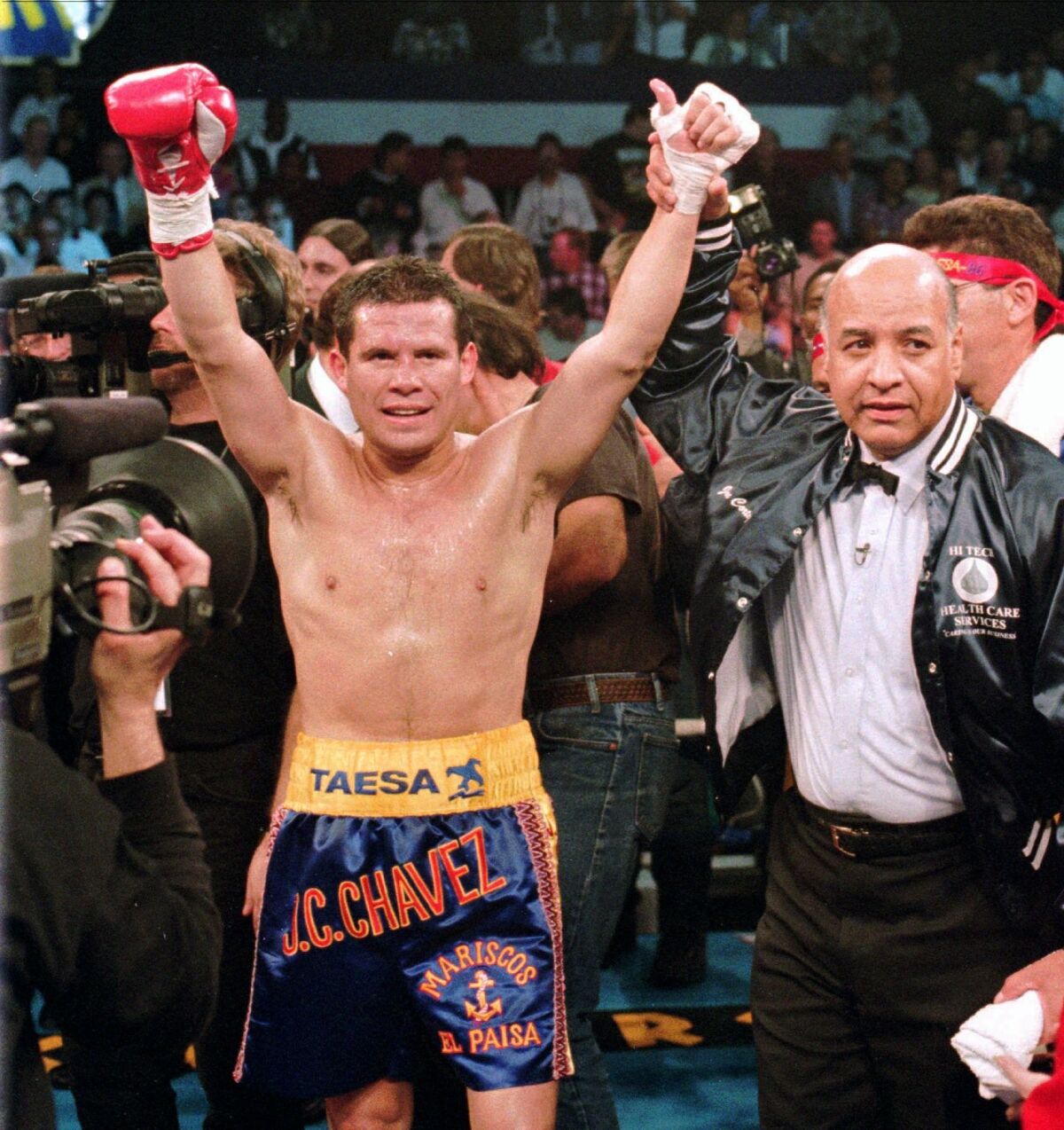 This Feb. 9, 1996, file photo shows WBC junior welterweight champion Julio Cesar Chavez, left, celebrating his victory over Scott Walker as referee Joe Cortez signals him the winner of their 10-round non-title bout in Las Vegas. Chavez and referee Cortez were selected Tuesday, Dec. 10, 2010, for induction into the International Boxing Hall of Fame and Museum.