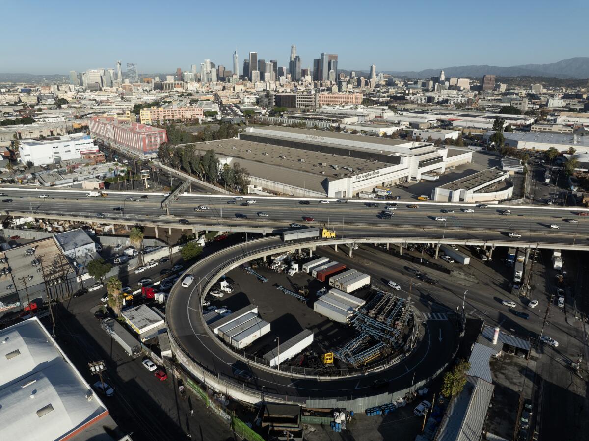 Aerial view of cars on a freeway with downtown in the background