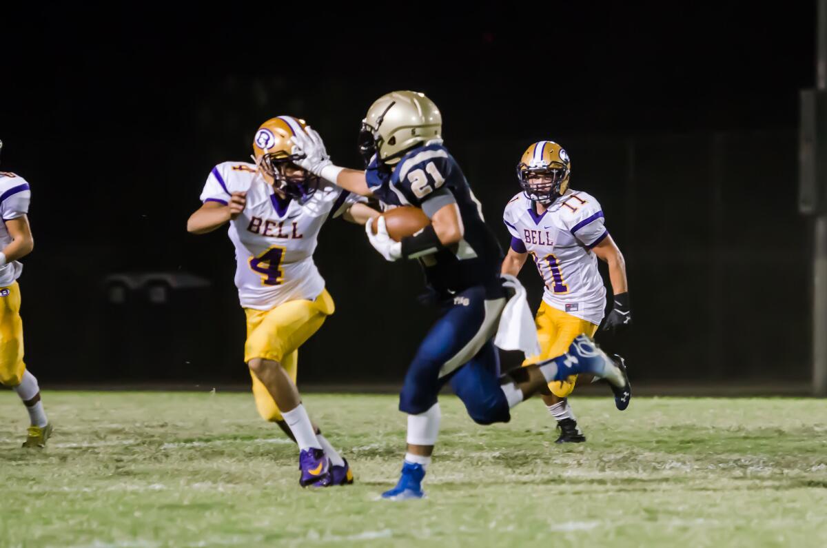 Guillermo Cordova of Franklin tries to escape tackle vs. Bell. He has 68 receptions this season.