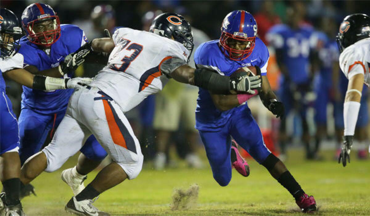 Serra running back Adoree' Jackson bursts through a hole as Chaminade defender Van Salomon tries to slow him down in a game in October.