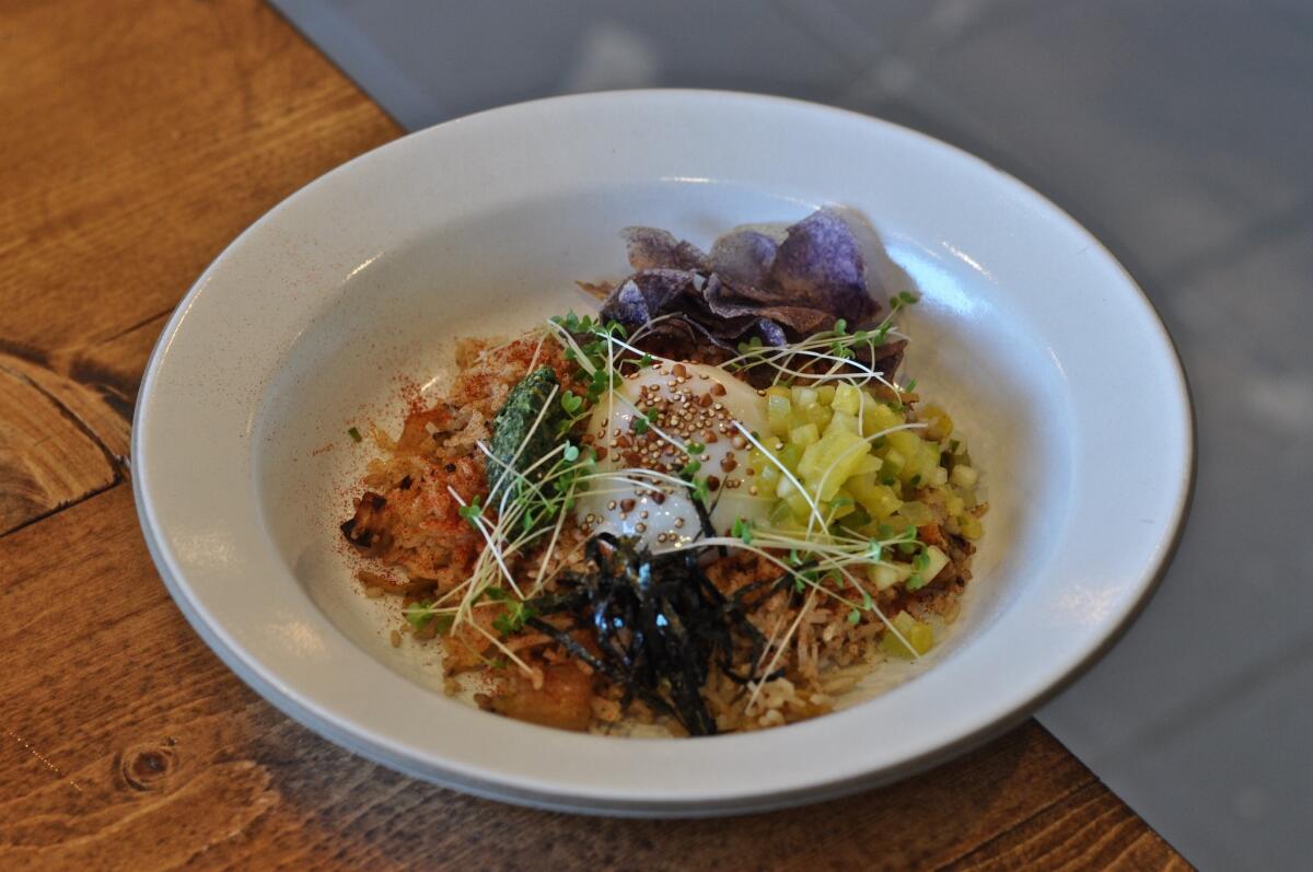 Kimchi fried rice at Baroo includes a 63-degree egg, basmati rice, purple potato chips, roasted seaweed and pineapple-fermented kimchi.