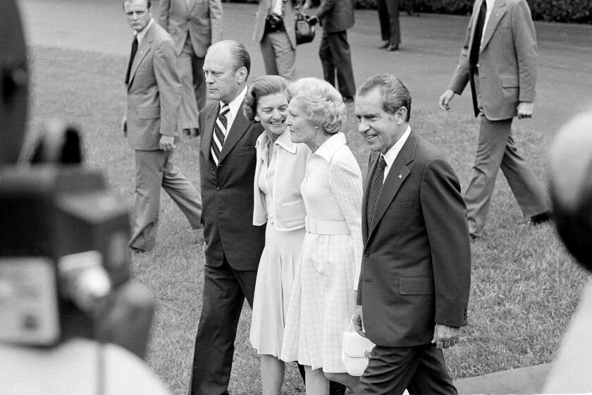 President Richard Nixon and first lady Pat Nixon, right, walk to a waiting helicopter accompanied by Vice President Gerald R. Ford and his wife Betty, as the Chief Executive prepares to leave the White House, Aug. 9, 1974. Pres. Nixon flew to nearby Andrews Air Force Base where he boarded Air Force One for a flight to California. (AP Photo)