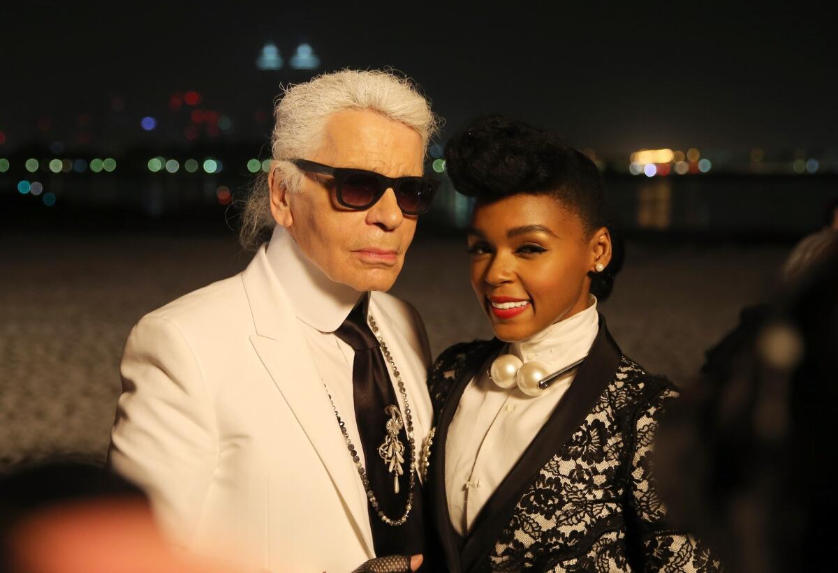 Designer Karl Lagerfeld poses with entertainer Janelle Monae after the Chanel Cruise Collection presentation in May in Dubai, United Arab Emirates.