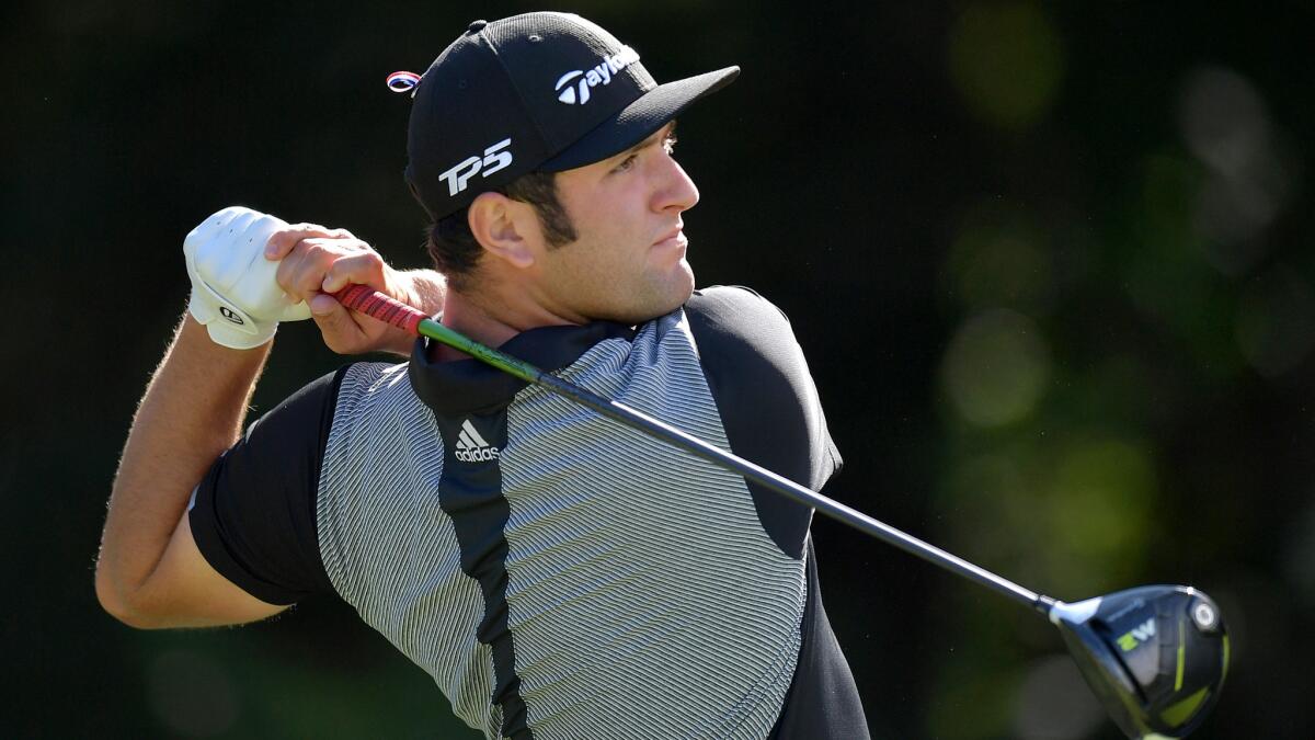 Jon Rahm follows through on a tee shot