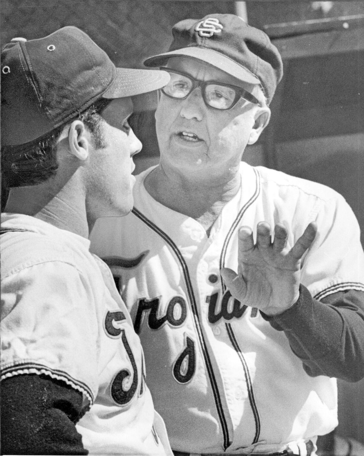 USC baseball coach Rod Dedeaux talks with one of his players during a game in 1970.