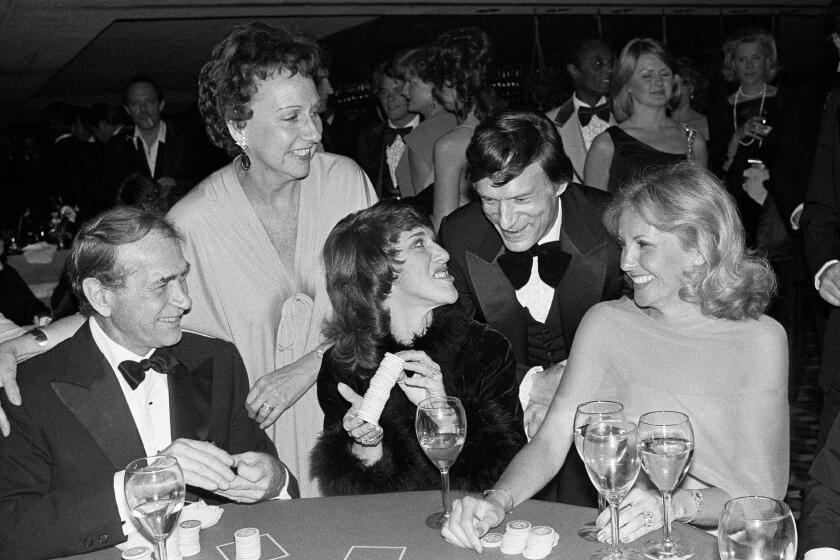 Actress Jean Stapleton, top left, and publisher Hugh Hefner laugh with, from foreground left, Darren McGavin, Ruth Buzzi and Barbara Fisher, during a black-tie casino fundraiser in Los Angeles in 1979.