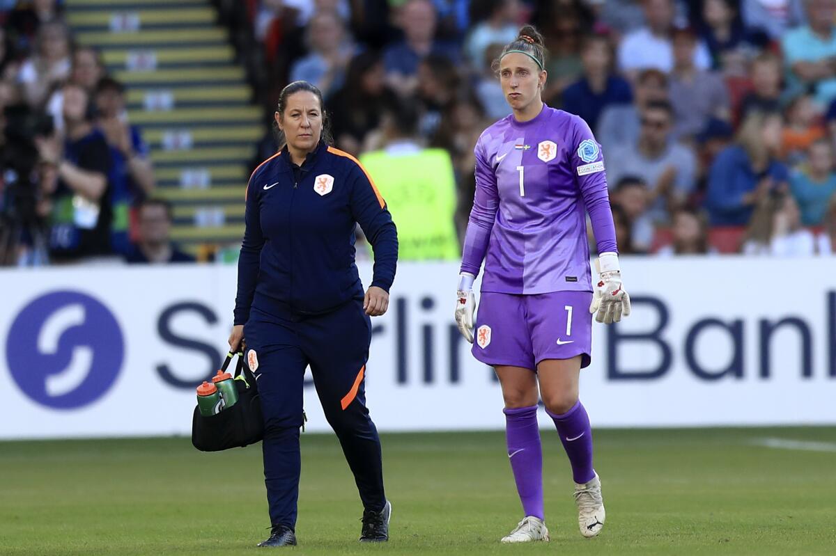 Netherlands' goalkeeper Sari van Veenendaal leaves the pitch to be substituted after getting injured during the Women Euro 2022 group C soccer match between the Netherlands and Sweden at Bramall Lane, Sheffield, England, Saturday, July 9, 2022. (AP Photo/Leila Coker)