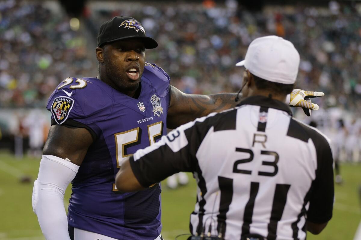 Baltimore's Terrell Suggs talks with referee Jerome Boger during the first half of Saturday's preseason game against Philadelphia.