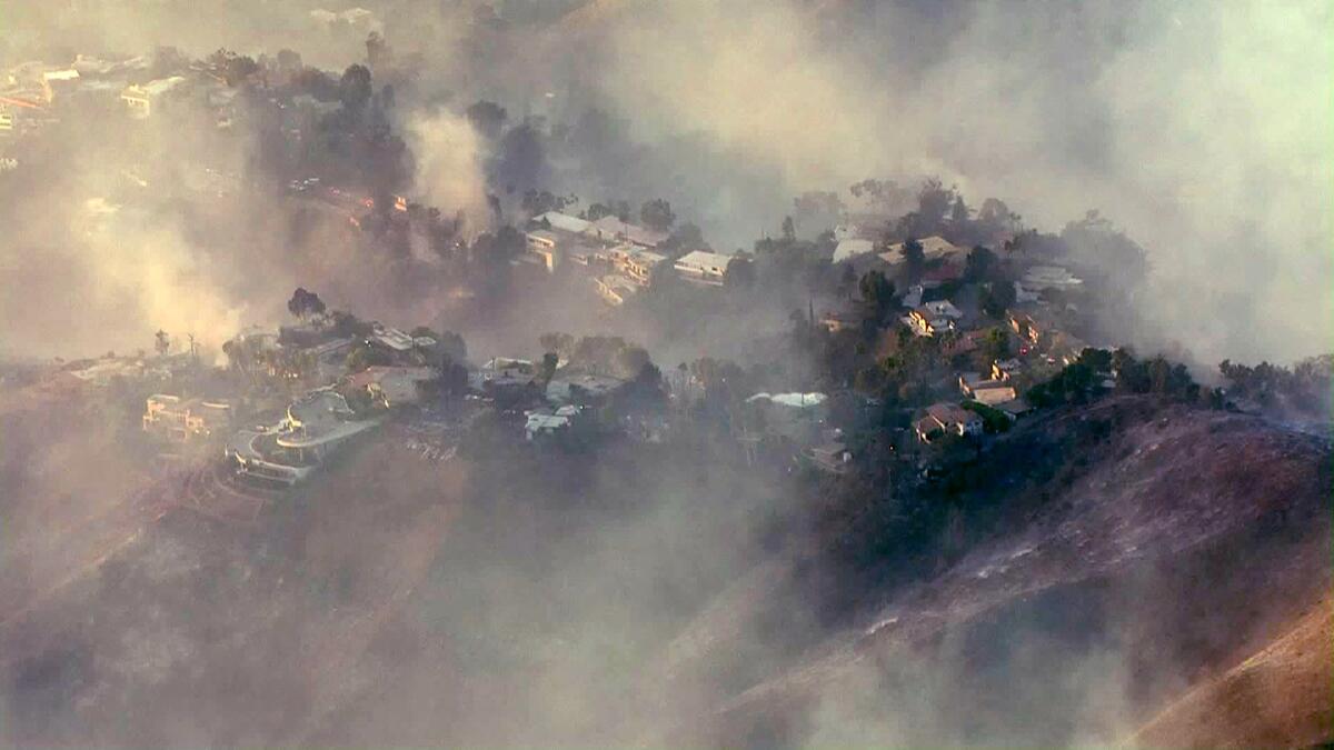 An aerial view of homes shrouded in smoke from the Getty fire.