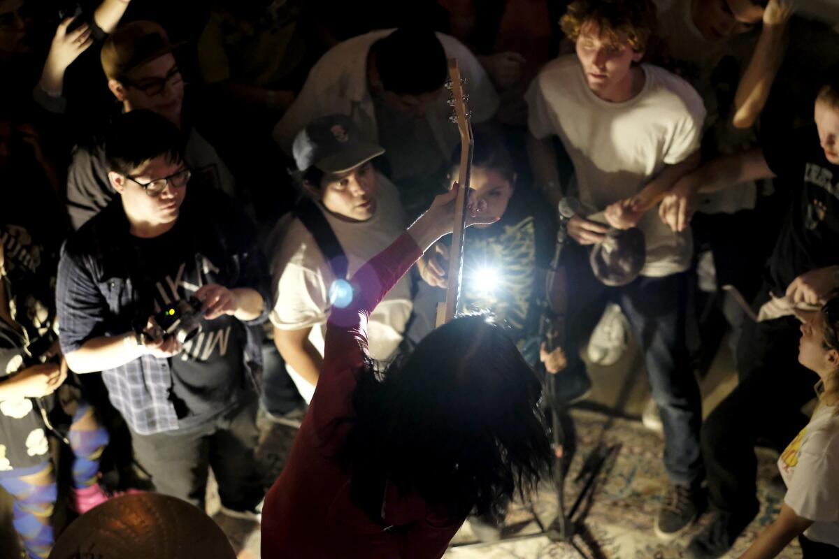 Fans gather around Kim House of Kim and the Created at a benefit for the Smell.