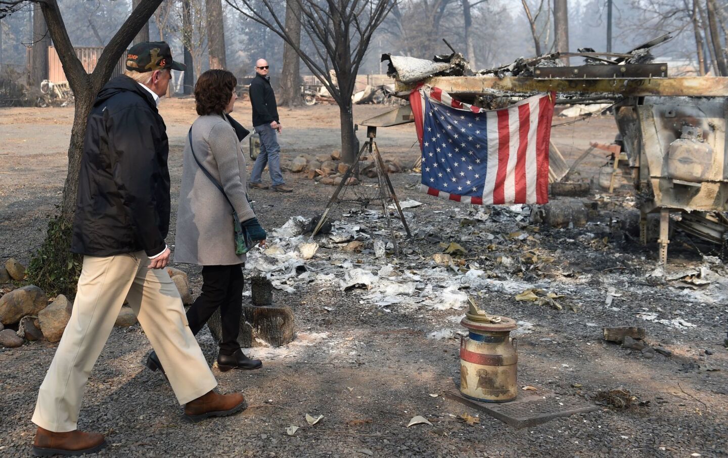 US President Donald Trump views damage from wildfires with Paradise Mayor Jody Jones in Paradise, Calif.
