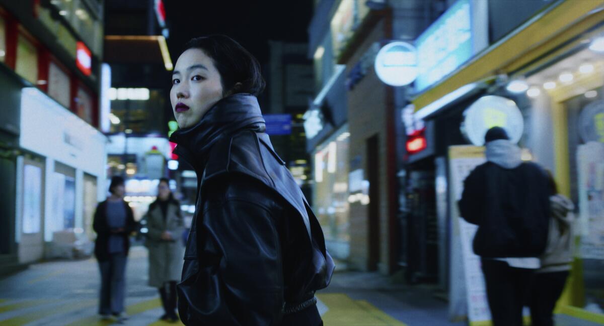 A young woman walks the streets of Seoul in the film "Return to Seoul."