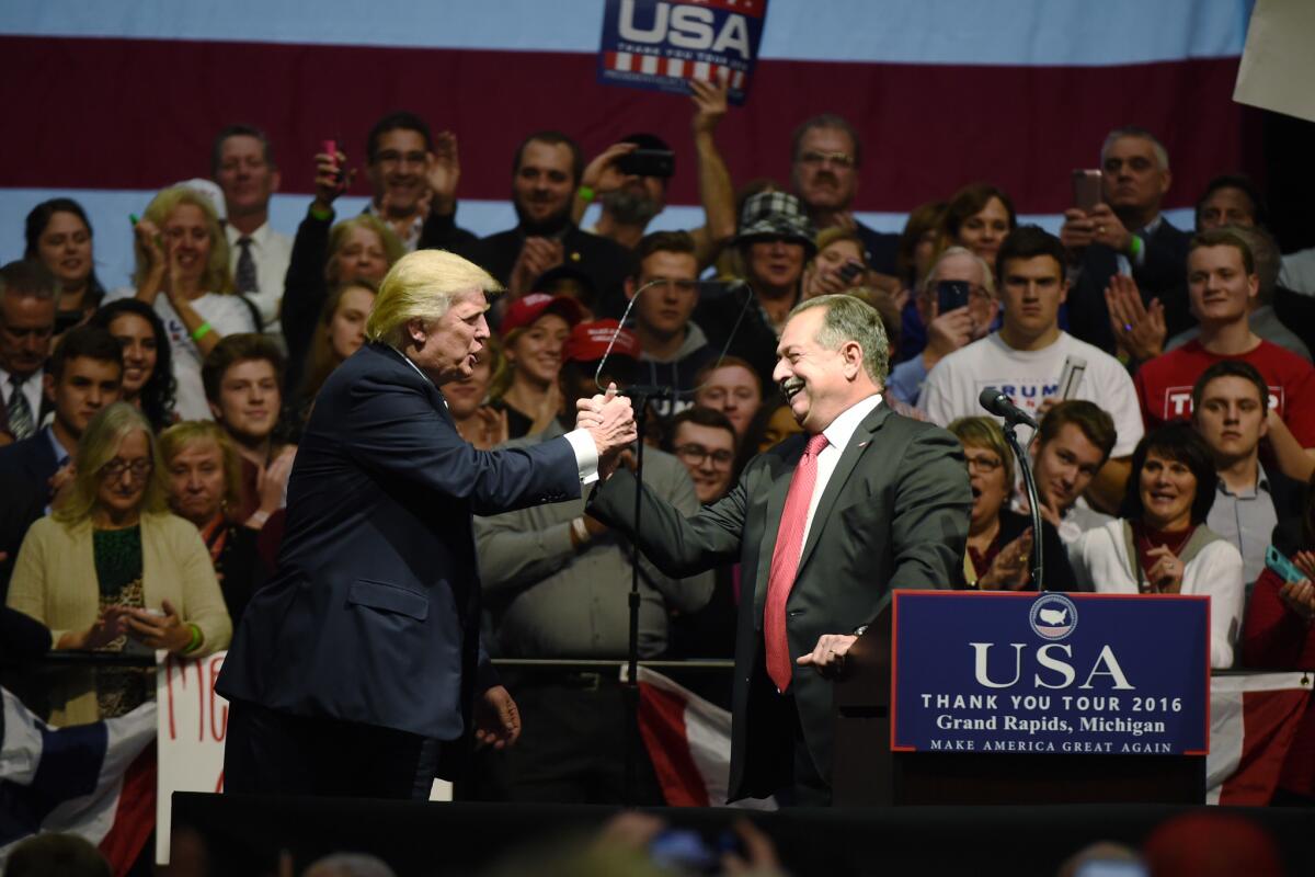 Donald Trump and Andrew Liveris at rally in Grand Rapids, Mich.