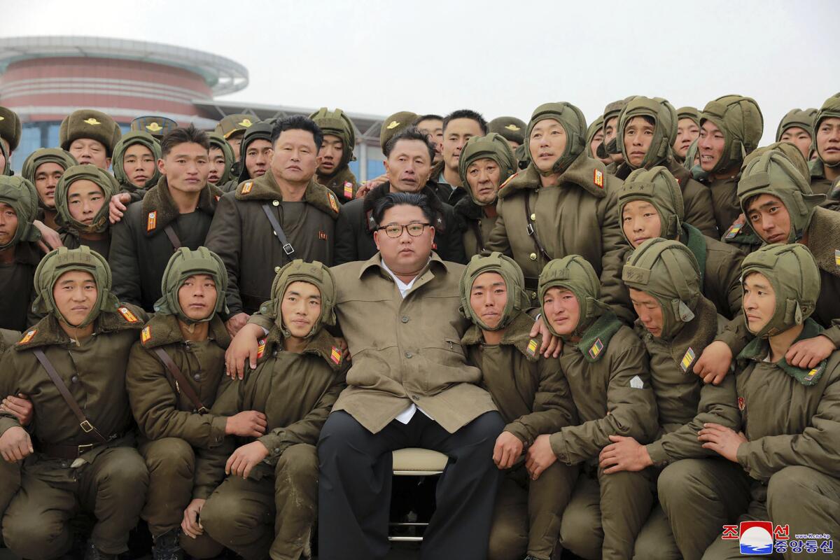 In a photo provided Monday, North Korean leader Kim Jong Un is pictured with air force sharpshooters and soldiers at an unknown location.
