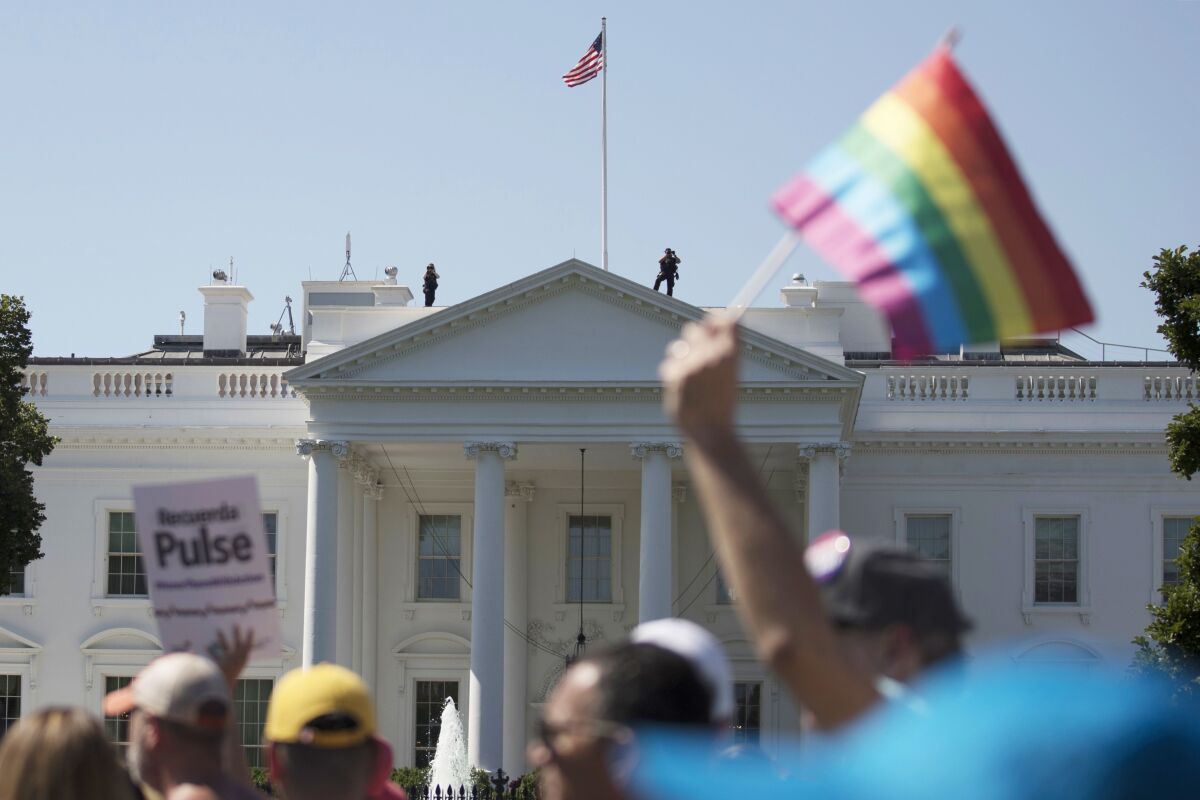 LGBTQ pride marchers pass White House