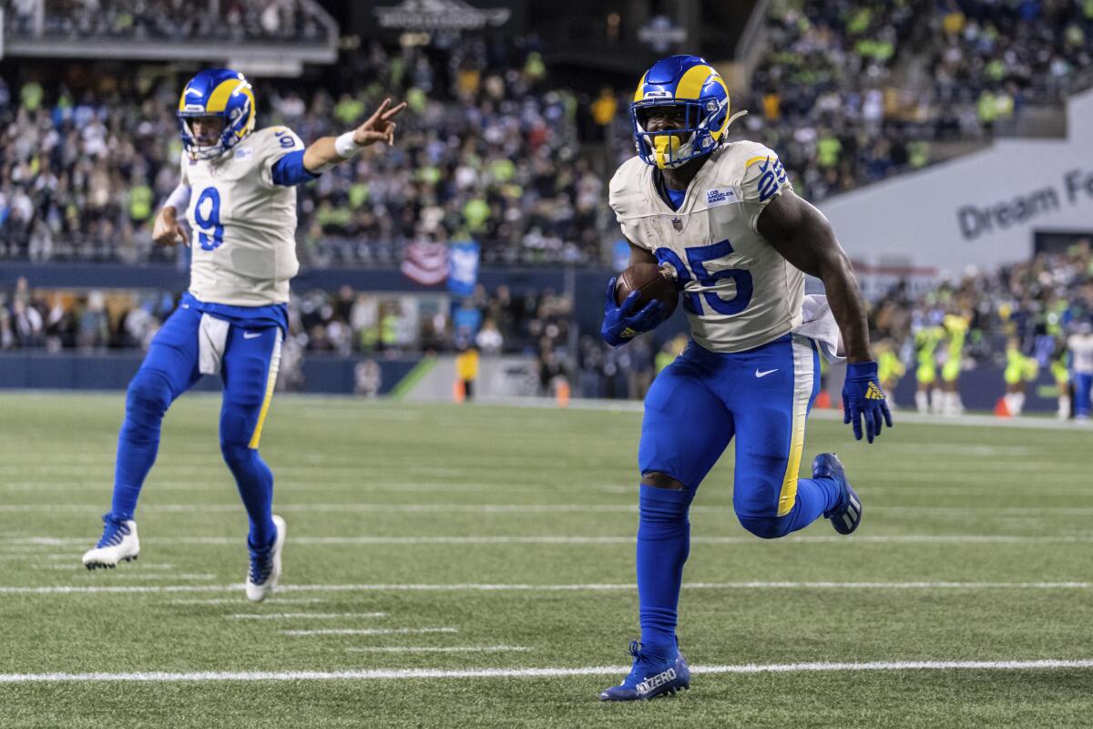 Rams running back Sony Michel scores a touchdown as quarterback Matthew Stafford celebrates.