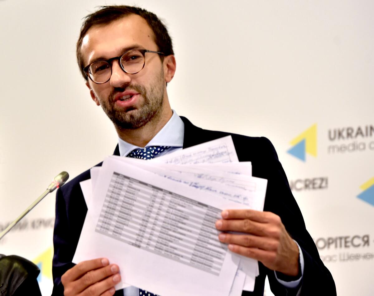 Ukrainian lawmaker Sergei Leshchenko holds pages purportedly from a ledger showing payments to Paul Manafort by the party of former Ukrainian President Viktor Yanukovich during a news conference in Kyiv in 2016.