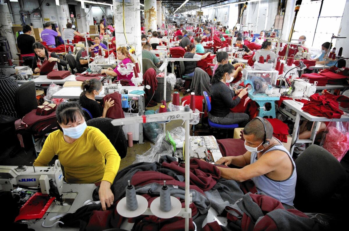 American Apparel employees are involved in cutting, sewing and packaging garments at the company's factory in L.A.