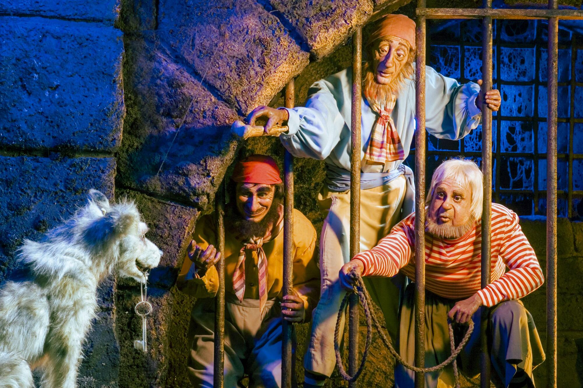 Audio-animatronic pirates on the Pirates of the Caribbean ride in a jail cell trying to lure a dog holding the key.