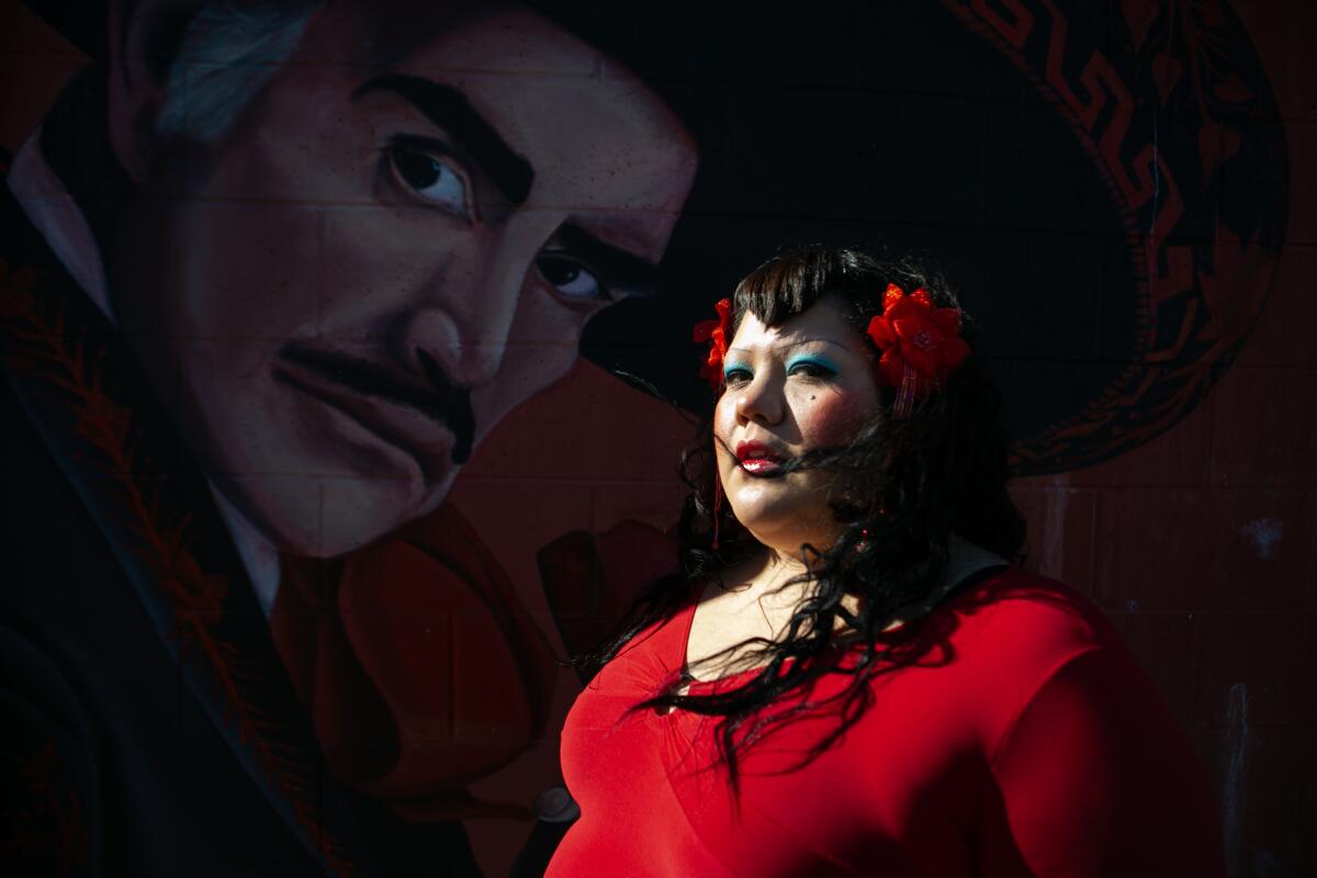 Gabriela Ruiz stands before a mural at Plaza del Valle market in Panorama City.